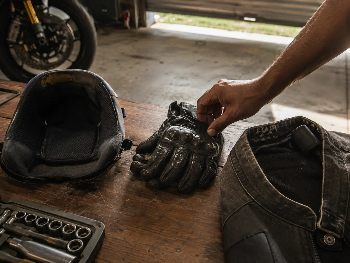 A rider's hands under warm bathroom light, unpacking a small hygiene kit after an evening ride.