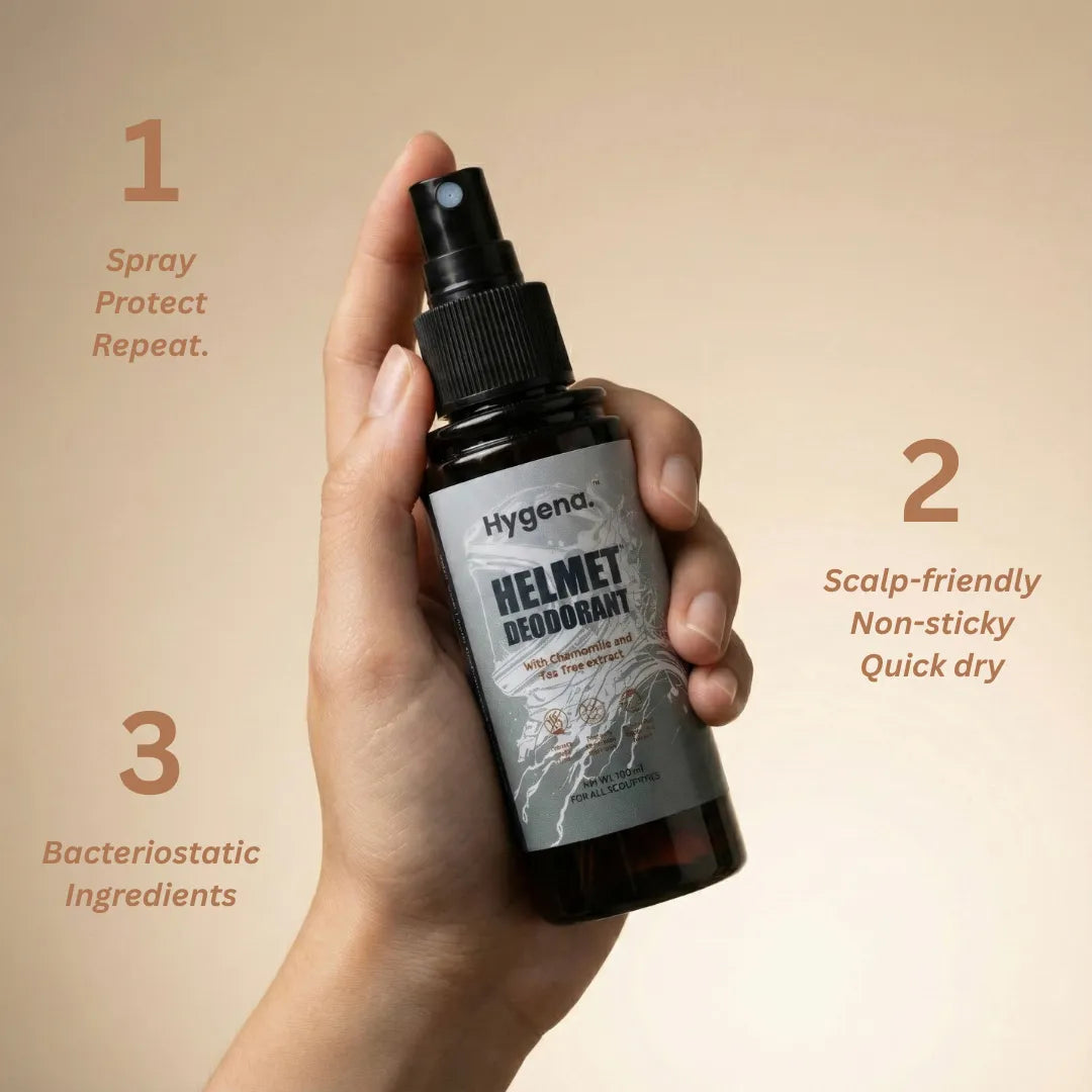Hand holding a bottle of Hygenda Helmet Deodorant with features listed on a beige background