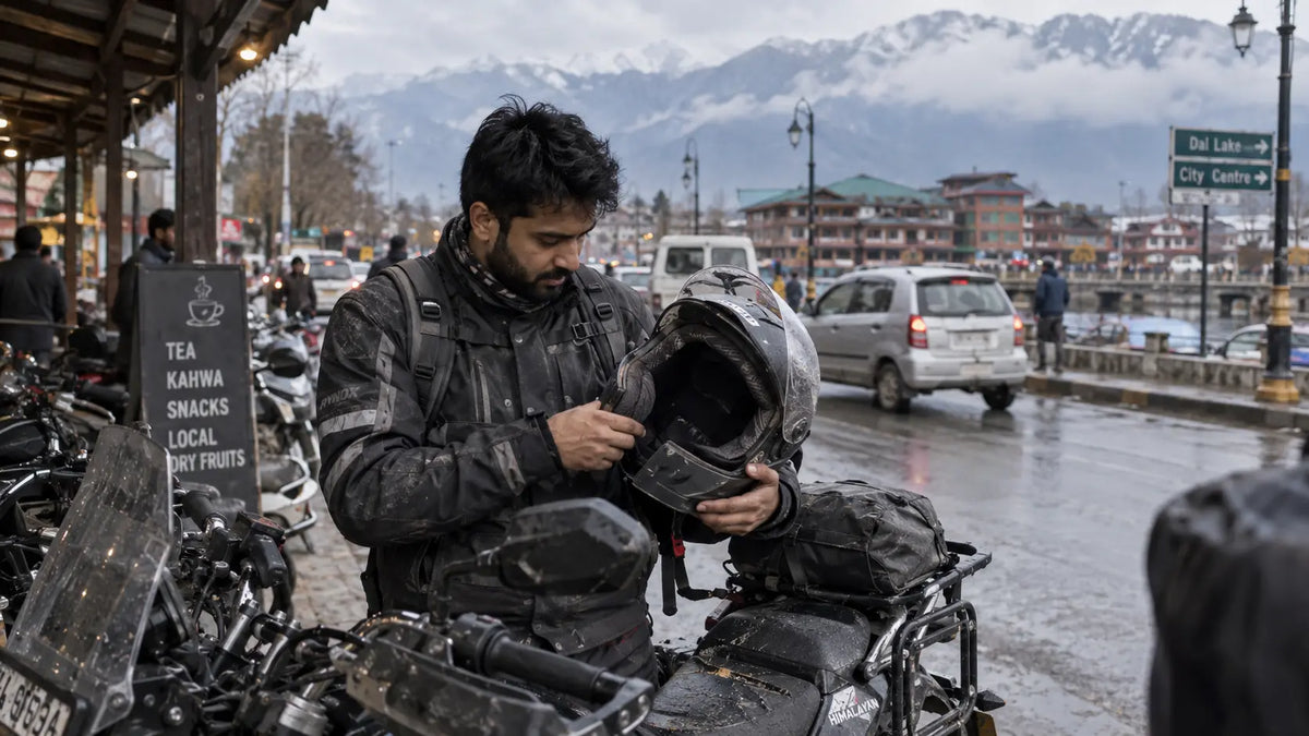 Srinagar rider opening a motorcycle helmet after a city commute near a busy road